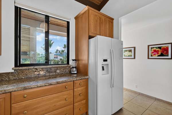 Fully equipped kitchen with granite countertops and wooden cabinetry