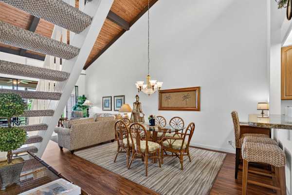 Dining area with wicker seating under vaulted ceilings
