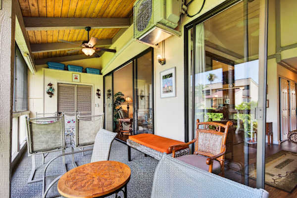 Covered lanai featuring comfortable patio seating and sliding glass doors
