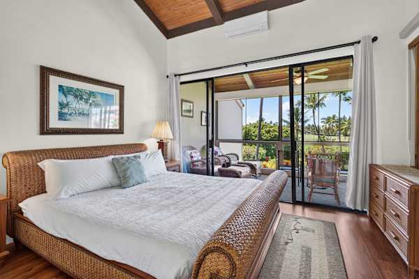 King bedroom with balcony access and outdoor views