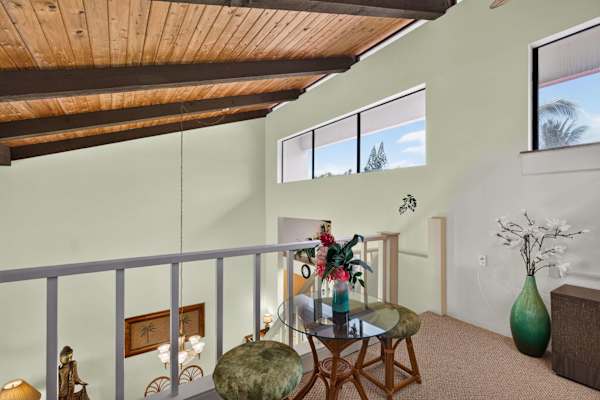 Upstairs loft overlooking living area with high clerestory windows