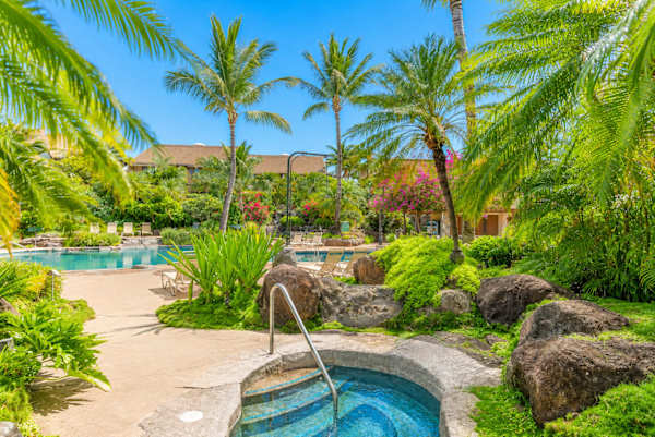 Pool curves through gardens creating island moments beneath palms