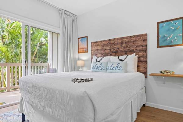 Queen Bed with Brick Accent Wall and Balcony Views