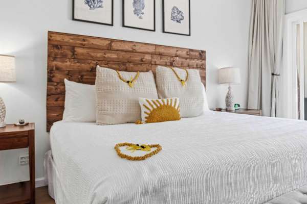 Cozy King Bed with Wood Headboard and Framed Art