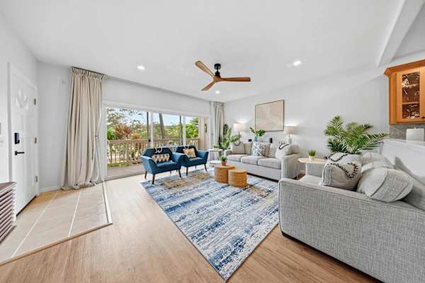 Bright Living Room with Balcony Access and Ocean Light