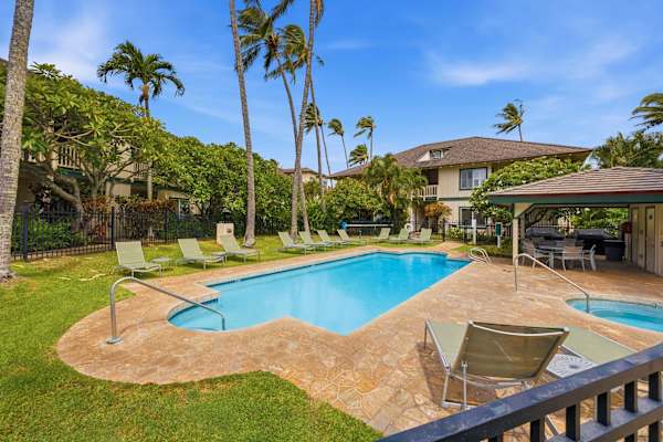 Pool with Loungers and Covered Cabana Under Palms
