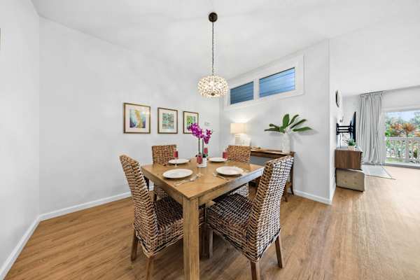 Elegant Dining Space with Pendant Light and Living Room Flow