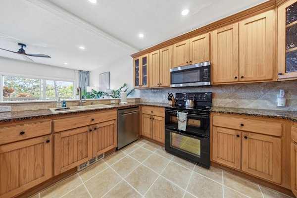 Spacious Kitchen with Granite Counters and Garden Views