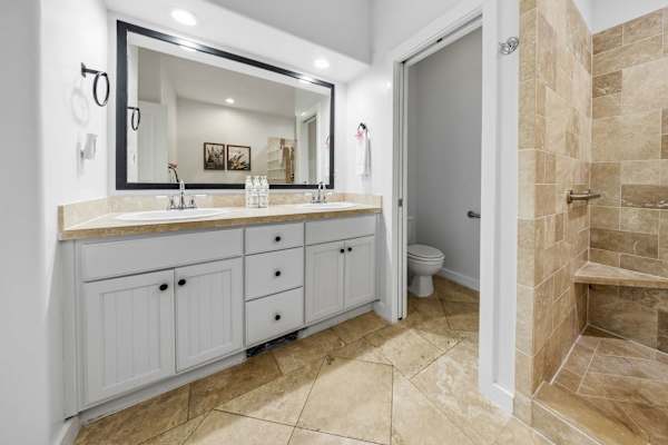 Vanity Bathroom with Framed Mirror and Walk-In Shower