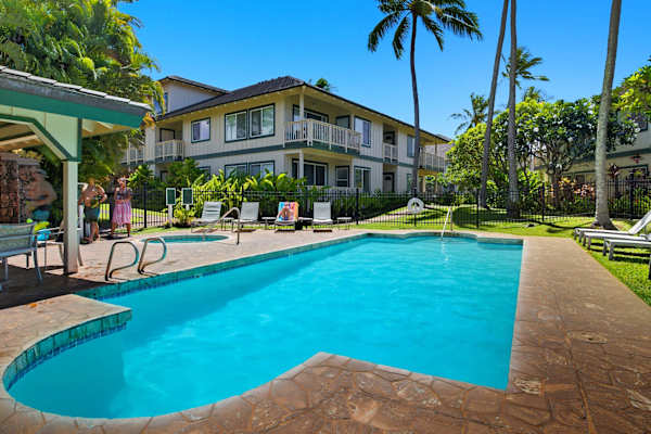 Turquoise Pool with Palm Trees and Lounge Chairs