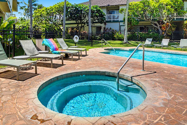 Round Hot Tub Beside the Community Pool and Loungers