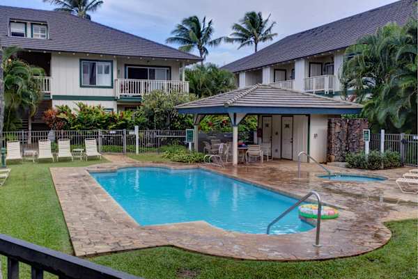 Community Pool with Covered Cabana and Palm Trees