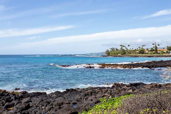 Lava Rock Coastline with Sandy Beach in the Distance