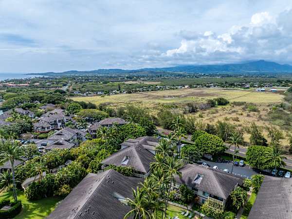 Aerial View of Rooftops with Mountain and Open Field Backdrop