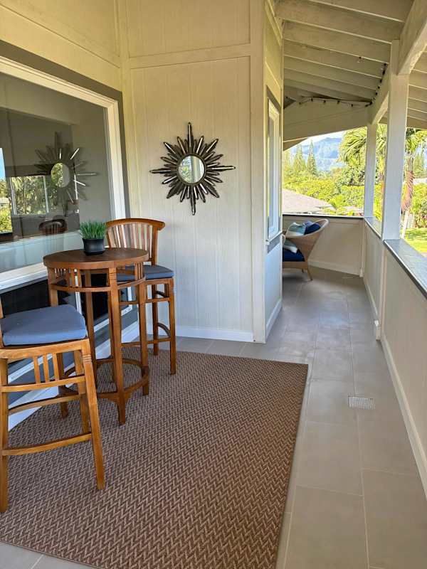 Covered balcony walkway featuring bistro seating & outdoor views