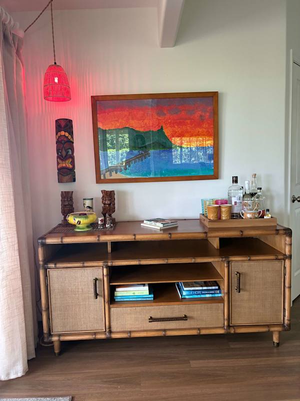 Woven wood credenza setup with accent light & wall decor