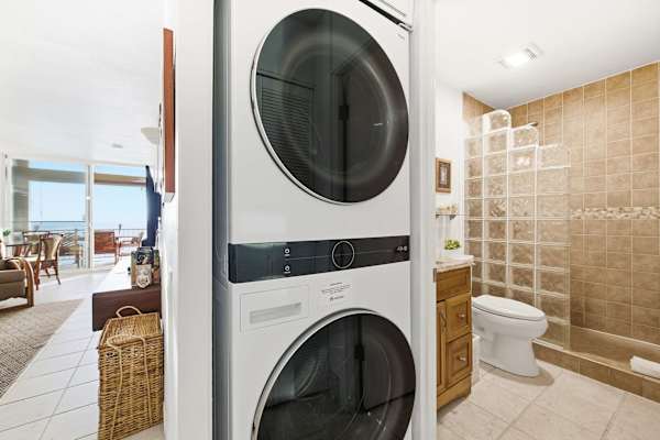Laundry area next to full bathroom