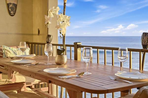 Dine on the lanai with sunset ocean waves crashing nearby.