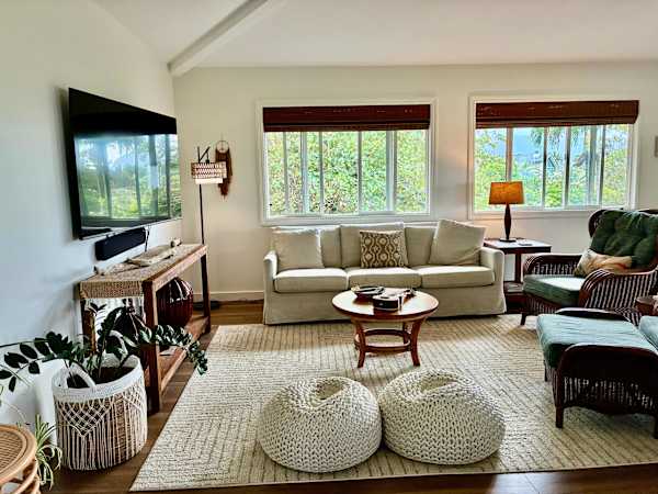 Bright and comfortable living room with plenty of seating and TV