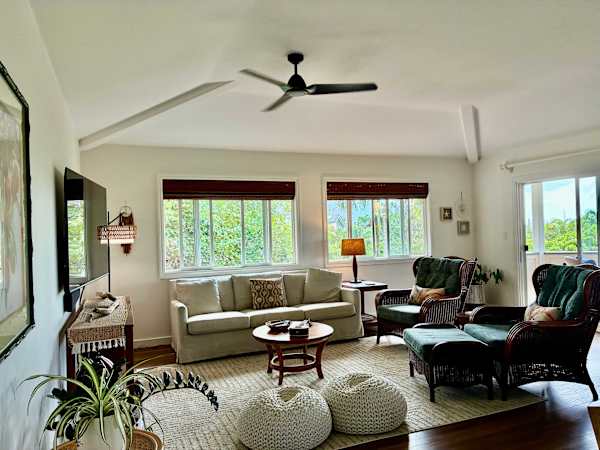 Bright and comfortable living room with plenty of seating and TV