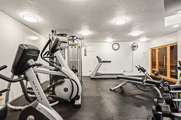 Keep up with your fitness routine in our fully equipped workout room, complete with cardio machines, weights, and a soothing sauna!