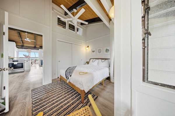 Third bedroom with ceiling fan and bright windows 