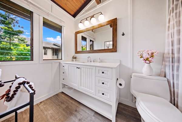 Primary bathroom with bright vanity 