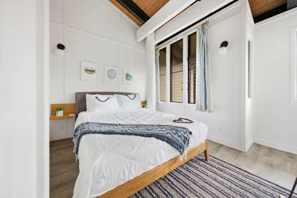 Third bedroom with queen bed and bright windows 