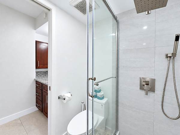 Get a quick reset in this modern bathroom with convenient shower glass doors, plus all your bathing essentials at easy reach