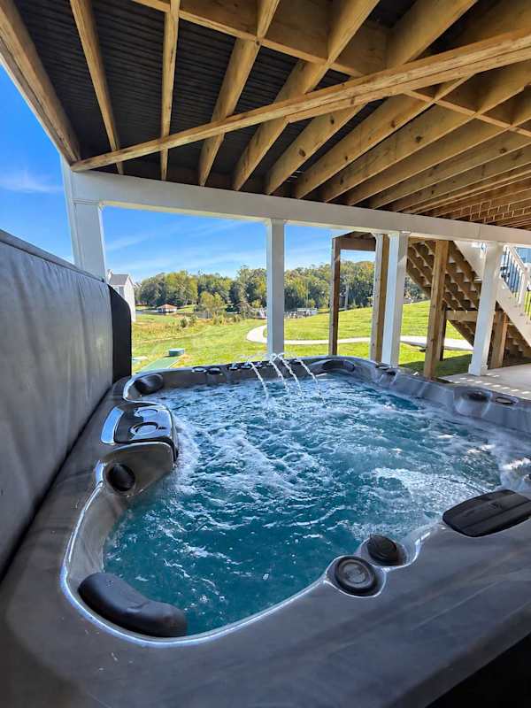 Private Hot Tub — Unwind and relax in your own bubbling hot tub, the perfect place to recharge after a day on the lake.