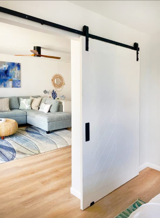 There is a sliding barn door that separates the bedroom and the living area.