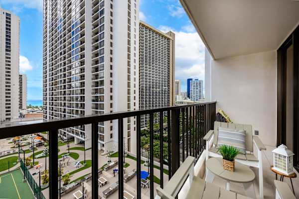Step onto your private balcony and take in city skyline views and comfortable outdoor seating.