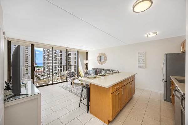 Unwind in a bright, open living space framed by floor-to-ceiling windows leading to a private balcony with city views.