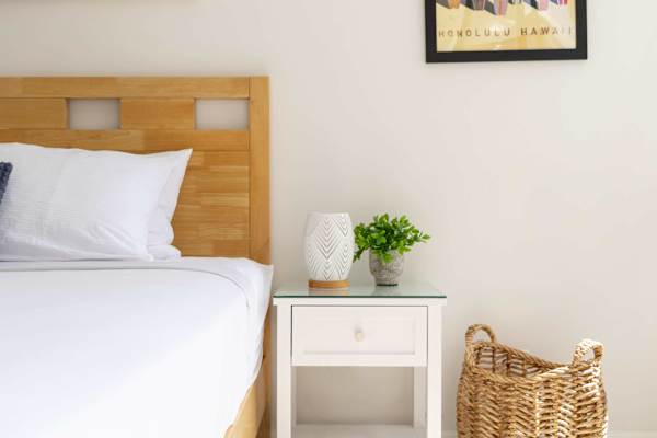 Thoughtful touches and clean, minimalist aesthetics create a tranquil bedside nook designed for effortless relaxation.