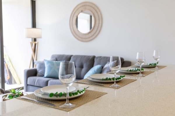 Dine in style at the elegant island bar, perfect for memorable meals with a cozy living area just beyond.