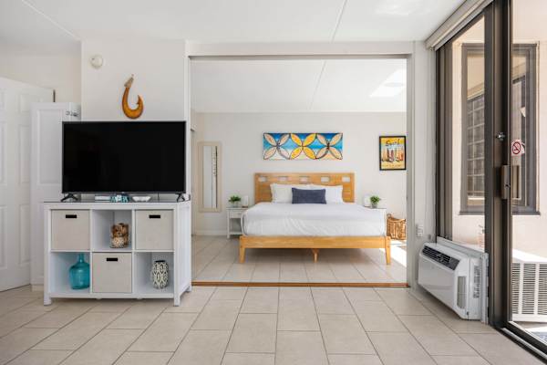 Experience effortless indoor-outdoor living with this bright, open-plan suite featuring a dedicated TV entertainment area and a king bedroom suite just beyond.