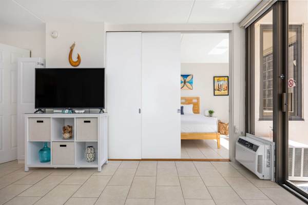 Enjoy versatile living with sliding partition doors that effortlessly separate the living area from the private bedroom suite.