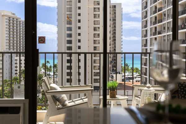 Step onto your private balcony and take in partial ocean views framed by city skylines and comfortable outdoor seating.