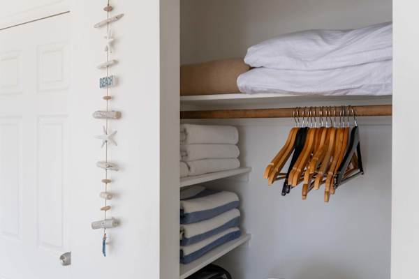 Stay organized and prepared with a well-stocked closet featuring extra plush linens, fresh towels, and plenty of wooden hangers for your convenience.