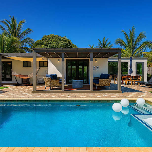 Mid-century ranch exterior with heated pool, managed by Chādy in Fort Lauderdale