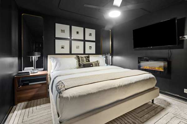 Descend to Bedroom #5 in the basement, a modern den with a king bed and warm ambiance, perfect for a private escape.