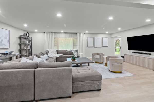 Bask in the comfort of our living room, designed for those who appreciate the finer things, like a 75-inch TV and elegant, modern decor.