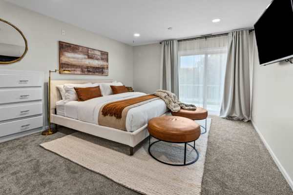 Indulge in the master suite's plush king bed, where luxury and dreams intertwine under the soft glow of chic lighting.