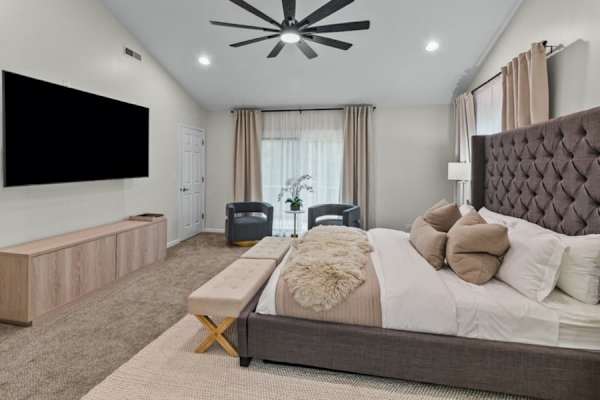 Indulge in the master suite's plush king bed, where luxury and dreams intertwine under the soft glow of chic lighting.