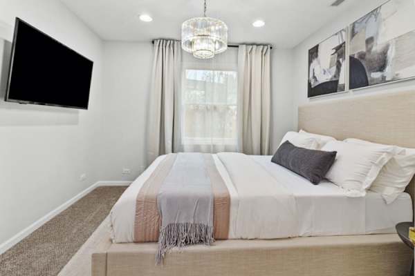 Enjoy the accessible luxury of Bedroom #4 on the main level, offering a cozy queen bed and tranquil decor for a peaceful night's rest.