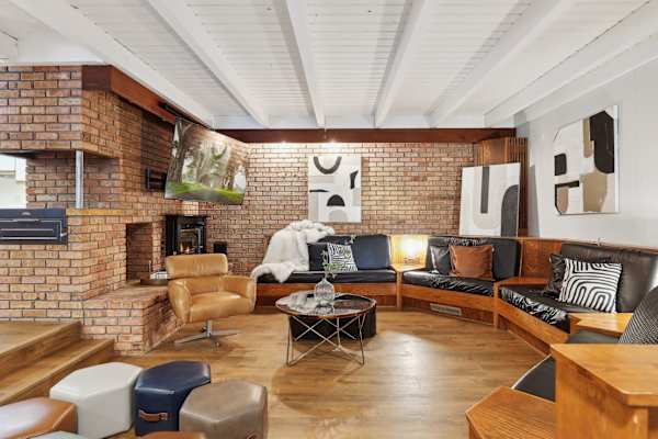 Retro elegance meets modern luxury in this lower-level lounge, a stylish nook for relaxation and socializing.