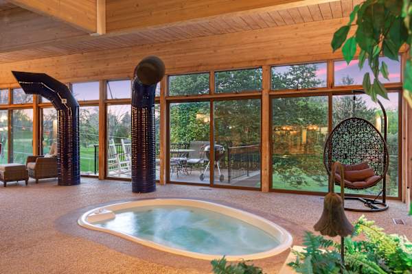 Relaxation awaits in this inviting indoor hot tub, where the bubbling waters and scenic views offer a tranquil escape from the everyday.