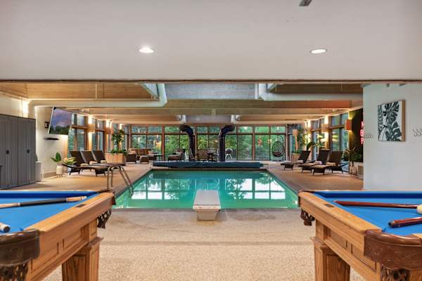Dive into relaxation in this expansive indoor pool, where comfort meets luxury under the soothing embrace of natural light.