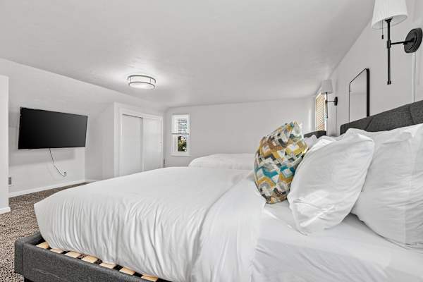 Spacious and inviting, Bedroom #4's twin queen beds offer a communal yet restful atmosphere.