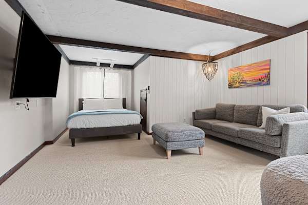 Bedroom #7: A loft-style haven with a queen bed, where simplicity meets comfort, offering a tranquil space to unwind.